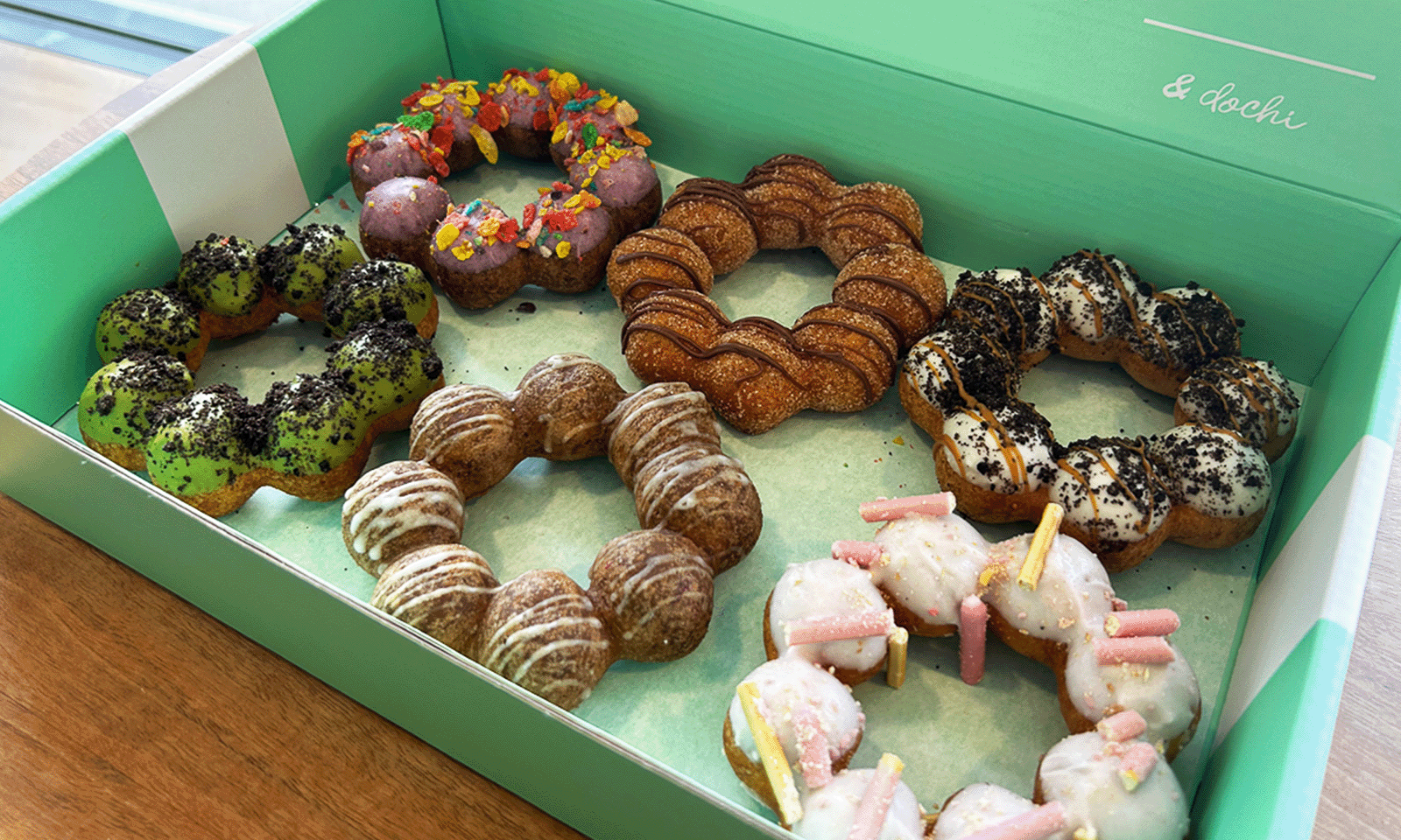 teal box of 6 dochi donuts with frosting